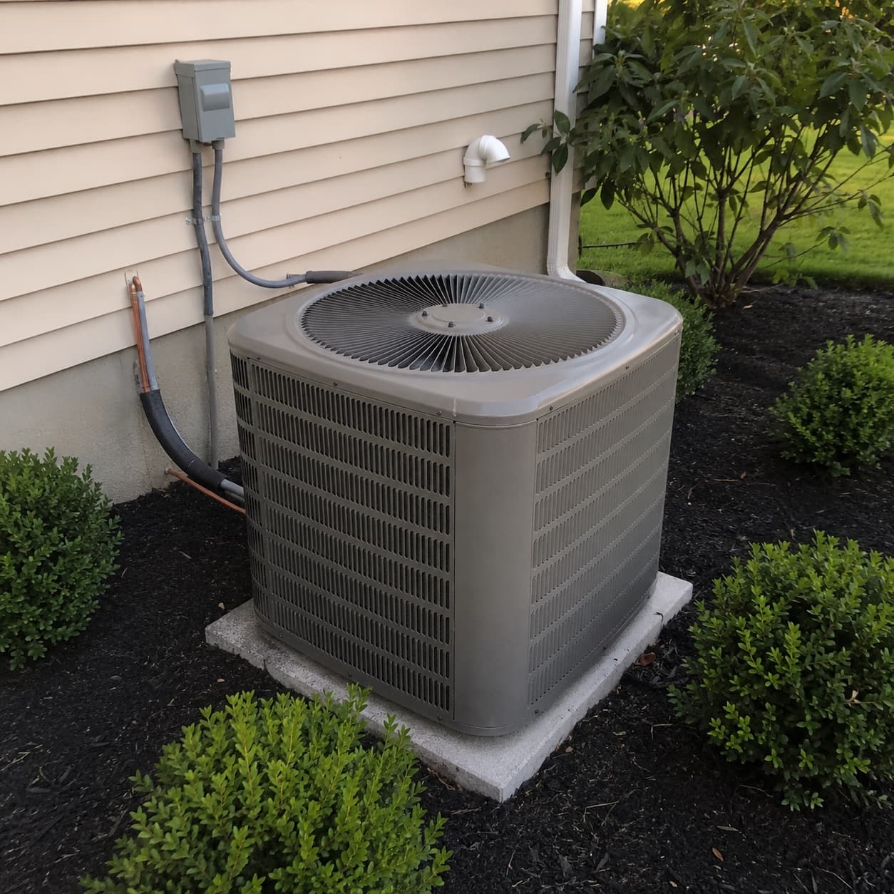 Conventional central air condenser outside a Long Island home Conventional central air condenser outside a Long Island home